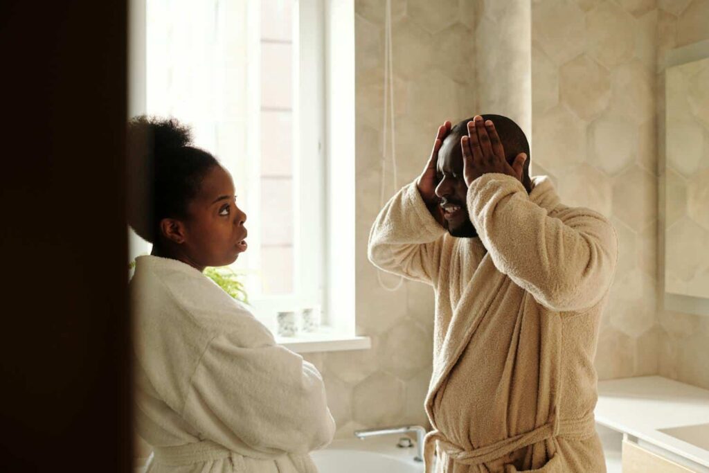 Couple experiencing tension during a difficult conversation, illustrating early signs that may benefit from marriage counselling.