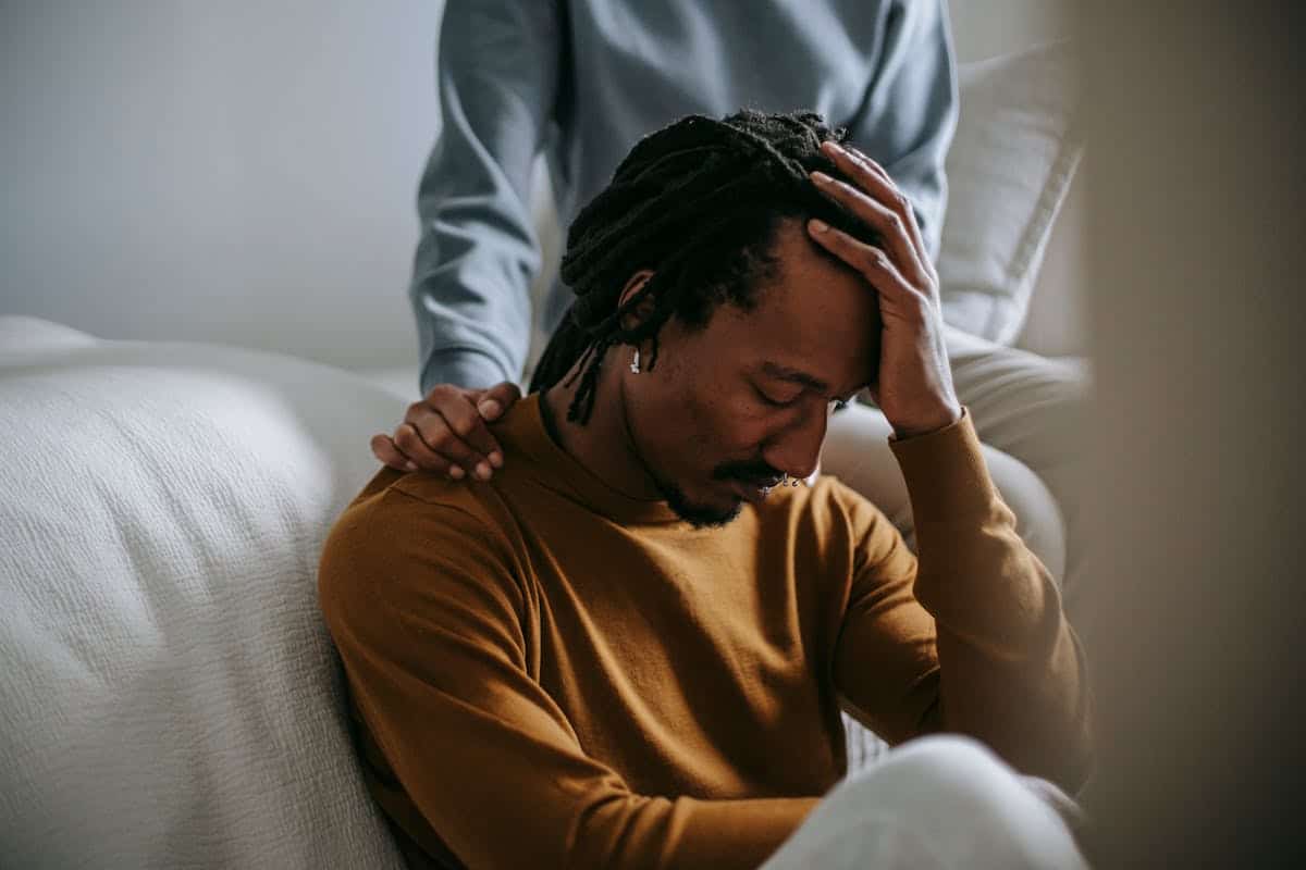 Person receiving emotional support during a first session with a grief counsellor.